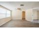 Spacious living room featuring light colored walls, new wood flooring, and plenty of natural light at 9811 Rainbow Ln, Port Richey, FL 34668