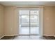 This living room offers a sliding glass door that leads to a screened porch at 9811 Rainbow Ln, Port Richey, FL 34668