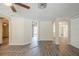 Spacious living room featuring light colored walls, new wood flooring, and arched doorways at 9811 Rainbow Ln, Port Richey, FL 34668