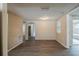 Open-concept living room showcasing neutral paint tones and dark gray wood flooring at 9811 Rainbow Ln, Port Richey, FL 34668