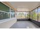 Screened porch features an unobstructed view of the large backyard at 9811 Rainbow Ln, Port Richey, FL 34668