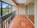 Outdoor balcony overlooking a grassy, green landscape with sliding doors to an indoor living space at 13516 Palmwood Ln, Tampa, FL 33618