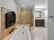 Elegant bathroom featuring a jacuzzi tub, a walk-in shower, and a vanity at 13516 Palmwood Ln, Tampa, FL 33618