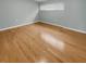 Inviting bedroom with a window providing ample natural light, complemented by sleek hardwood floors at 13516 Palmwood Ln, Tampa, FL 33618