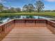 Relax on this wood deck with scenic views of the pond and golf course in the backyard at 13516 Palmwood Ln, Tampa, FL 33618