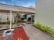 Charming front entrance featuring a covered walkway and beautiful landscaping at 13516 Palmwood Ln, Tampa, FL 33618