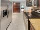 Well-lit kitchen featuring stainless steel appliances, granite countertops, and wooden cabinets at 13516 Palmwood Ln, Tampa, FL 33618