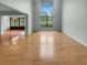 Bright living room with hardwood floors and large windows that bring in natural light at 13516 Palmwood Ln, Tampa, FL 33618
