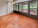 Sunroom with terra cotta tile and sliding doors to deck with pond views at 13516 Palmwood Ln, Tampa, FL 33618