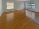 A spacious and bright living room featuring hardwood floors and large windows at 14440 Wake Robin Dr, Brooksville, FL 34604