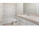 Well-lit bathroom with a shower-tub combination and a single sink vanity at 32859 Pez Landing Ln, Wesley Chapel, FL 33543