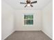 Carpeted bedroom with natural light and ceiling fan provides a bright, airy feel at 32859 Pez Landing Ln, Wesley Chapel, FL 33543