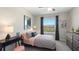Charming bedroom with stylish decor, a window view, and a ceiling fan at 32859 Pez Landing Ln, Wesley Chapel, FL 33543