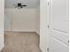 Bright bedroom featuring neutral carpet, a ceiling fan, and a large window at 32859 Pez Landing Ln, Wesley Chapel, FL 33543