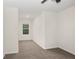 Bright, carpeted bedroom with a window view, ceiling fan, and ample space at 32859 Pez Landing Ln, Wesley Chapel, FL 33543