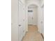 Bright hallway features tile floors and an arched doorway leading to the front door at 32859 Pez Landing Ln, Wesley Chapel, FL 33543