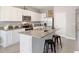 Well-lit kitchen with granite counters, stainless appliances, a center island, and breakfast bar at 32859 Pez Landing Ln, Wesley Chapel, FL 33543