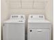 Laundry room with a white, front-load washer and dryer at 32859 Pez Landing Ln, Wesley Chapel, FL 33543