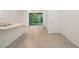 Open-concept living space with tile flooring and sliding doors leading to the backyard at 32859 Pez Landing Ln, Wesley Chapel, FL 33543