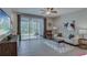 Cozy living room featuring tile flooring, sliding glass doors to a patio, and stylish decor at 32859 Pez Landing Ln, Wesley Chapel, FL 33543