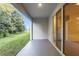 Covered patio with a sliding glass door and a view of the backyard at 32859 Pez Landing Ln, Wesley Chapel, FL 33543