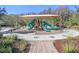 Community playground with slides, climbing structures, and a covered seating area at 32859 Pez Landing Ln, Wesley Chapel, FL 33543