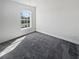 Cozy bedroom featuring neutral carpet, a window, and white walls at 7415 Terrace River Dr, Temple Terrace, FL 33637