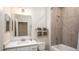 Bathroom with a tiled tub and shower, a white vanity with a sink, and decorative towel rack at 25138 Calusa Dr, Punta Gorda, FL 33955