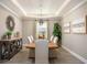Elegant dining room with stylish light fixture, table set for six, and decorative console table with plants at 25138 Calusa Dr, Punta Gorda, FL 33955
