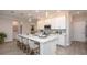 Bright kitchen featuring white cabinets, stainless steel appliances, large island with countertop dining, and pendant lighting at 25138 Calusa Dr, Punta Gorda, FL 33955