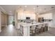 Bright kitchen featuring white cabinets, stainless steel appliances, large island with countertop dining, and pendant lighting at 25138 Calusa Dr, Punta Gorda, FL 33955