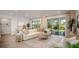 Bright living room featuring a comfortable, neutral-colored sectional sofa and plenty of natural light from sliding glass doors at 25138 Calusa Dr, Punta Gorda, FL 33955