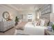 Calm main bedroom suite with a soft color palette, tray ceiling, and a decorative dresser with mirror at 25138 Calusa Dr, Punta Gorda, FL 33955