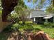 Lush backyard featuring a screened-in porch and privacy fence at 4906 W Cleveland St, Tampa, FL 33609