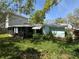 Lush backyard featuring a screened-in porch and mature landscaping at 4906 W Cleveland St, Tampa, FL 33609