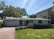 Charming single-story home with a brick driveway and mature landscaping at 4906 W Cleveland St, Tampa, FL 33609