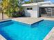 Swimming pool with blue water, gray pavers, and black iron fence at 513 Flamingo Dr, Apollo Beach, FL 33572