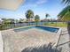 Backyard with newly built pool featuring brick pavers, privacy fencing, and views of the canal and surrounding landscape at 513 Flamingo Dr, Apollo Beach, FL 33572