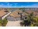 Aerial view of a beautiful home with a tile roof and a lake view in the background at 17936 Polo Trl, Bradenton, FL 34211
