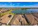 Wide aerial view of a home with solar panels and a scenic lake in the background at 17936 Polo Trl, Bradenton, FL 34211