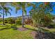 Scenic backyard featuring vibrant hibiscus trees and views of the screened in pool area at 17936 Polo Trl, Bradenton, FL 34211
