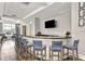 Interior view of a bar with chairs, a TV, and modern decor in the community clubhouse at 17936 Polo Trl, Bradenton, FL 34211