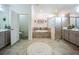 Luxurious bathroom featuring a soaking tub, glass shower, and double vanity for a spa-like experience at 17936 Polo Trl, Bradenton, FL 34211