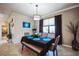 Cozy dining area with neutral décor, a modern chandelier, and a view to other rooms at 17936 Polo Trl, Bradenton, FL 34211
