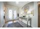 Bright foyer with a decorative mirror and console table at 17936 Polo Trl, Bradenton, FL 34211