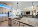 Kitchen with stainless steel appliances, granite countertops, and a central island with sink at 17936 Polo Trl, Bradenton, FL 34211