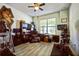 Spacious office featuring wood flooring, ceiling fan, dark furniture and natural lighting at 17936 Polo Trl, Bradenton, FL 34211