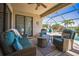 Inviting screened patio with wicker furniture overlooking the lush landscaping and scenic waterfront at 17936 Polo Trl, Bradenton, FL 34211