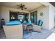 Covered patio with stylish wicker seating, perfect for enjoying serene outdoor moments at 17936 Polo Trl, Bradenton, FL 34211