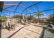 Stunning screened-in pool area with spa, lounge chairs, dining set, and lush landscaping at 17936 Polo Trl, Bradenton, FL 34211